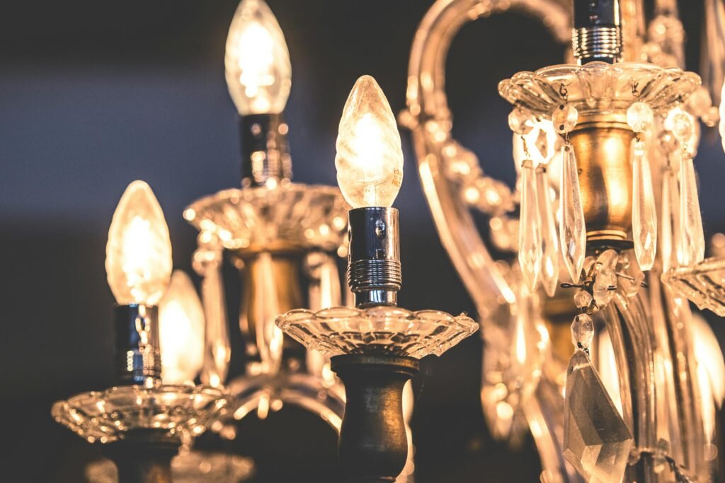 Close-up of a luxurious crystal chandelier with glowing bulbs and teardrop decorations.